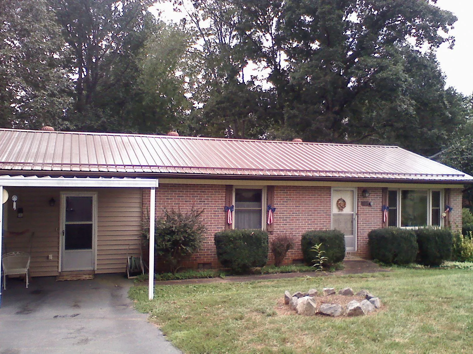 Bronze metal roof and carport on a brick ranch home — Roof Repair work by our crew in Glassboro